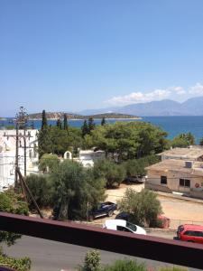 a view of a parking lot next to the water at Dilina Guesthouse in Agios Nikolaos