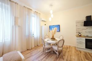 une cuisine et une salle à manger avec une table et des chaises dans l'établissement OKRA Apartment Pescara Centro, à Pescara