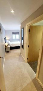 a room with a bedroom with a bed and a door at Stunning Apartment overlooking Pembroke Castle in Pembroke