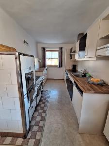 a kitchen with white appliances and a counter top at Schlömmerhaus in Michaelerberg