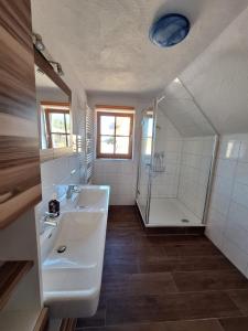 a bathroom with a tub and a sink and a shower at Schlömmerhaus in Michaelerberg