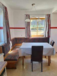 a dining room with a table and a window at Schlömmerhaus in Michaelerberg