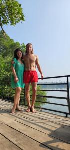 a man and a woman standing on a boardwalk at Lakefront Beach Homes in Cherai Beach