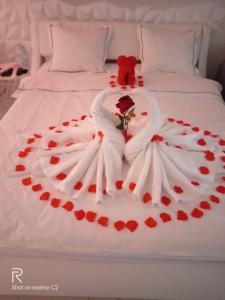 a wedding dress on a bed with red hearts at CENTRAL HOUSE - Studios with exclusive use of a Jacuzzi and optional Prosecco with full access to sauna, gym and play pool facilities - Studia z prywatnym Jacuzzi i opcją z Prosecco oraz dostępem do sauny, siłowni i bilarda in Warsaw