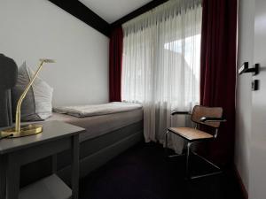 a bedroom with a bed and a desk and a window at New exclusive 2 bedroom apartment Hamburg in Hamburg