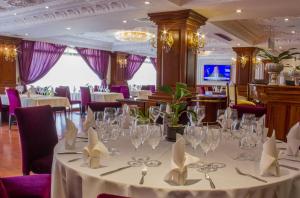 un comedor con una mesa con gafas. en Regency Angkor Hotel, en Siem Reap