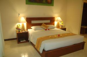 a bedroom with a bed with christmas decorations on it at Gunakaya Homestay in Sanur