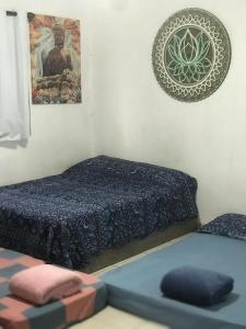 a bedroom with a bed and a picture on the wall at Residencial Segundo Piso in Garopaba