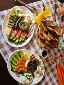 two plates of food on a table with plates of food at River Glamping Kalopanayiotis in Kalopanayiotis