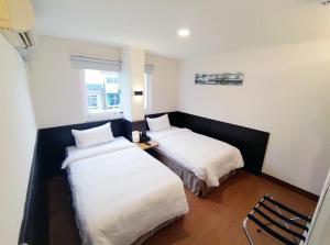 Voodi või voodid majutusasutuse 富裕商旅 RICH-hotel toas