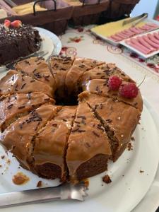 a chocolate cake with chocolate frosting on a plate at Hotel Formigas na Figueira in Tibagi