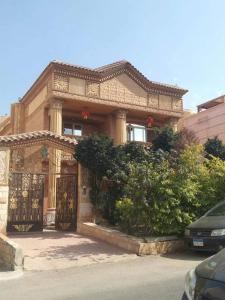 a house with a gate in front of it at 利人市 in Madinaty