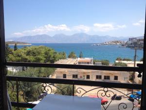 a view of the ocean from a balcony at Dilina Guesthouse in Agios Nikolaos