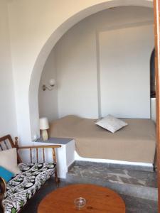 a small room with a bed and a table at Dilina Guesthouse in Agios Nikolaos