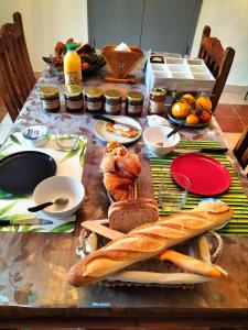 a table with bread and other food on it at Les chambres du roc St Jean in Gluiras