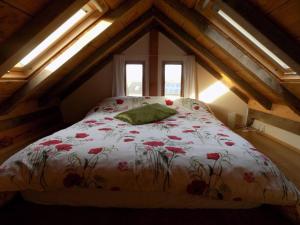 a bedroom with a bed with flowers on it at Log Cabin at The Old Summer Dairy Glastonbury in Somerton
