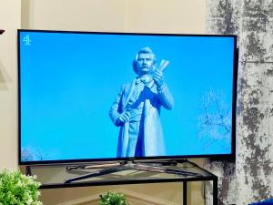a flat screen tv with a statue of a man at 2 Bedroom Flat In Central London in London