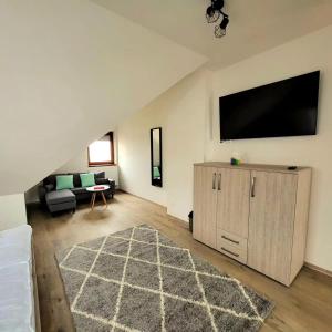 a living room with a flat screen tv on the wall at Apartmány Louka in Vaclavov u Bruntalu