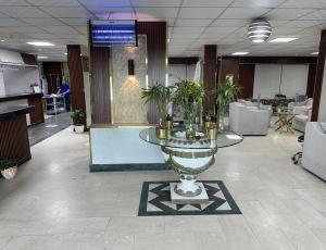 a lobby with a table with plants on it at Al Farhan Apartment (Al Jubail-Al Balad ) in Al Jubail