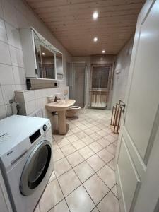 een badkamer met een wasmachine en een wastafel bij Soho Ferienwohnung in Rodenbach