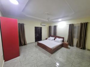 a bedroom with a bed in a room at B's Classic and Cozy Apartments in Cape Coast