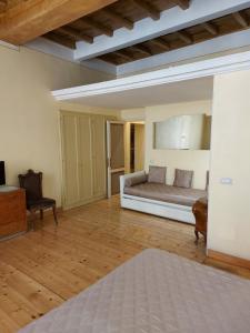 a large bedroom with a bed and a chair at Residenza Al Corso Suites in Rome