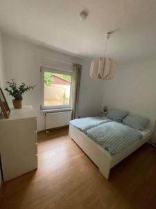 a bedroom with a bed and a window at WaldmeisterInn in Machern