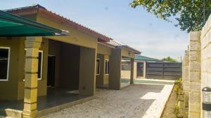 a small house with a patio at KKI Serviced Apartments in Lusaka