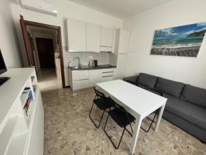 a living room with a white table and a couch at HOST IN LEVANTO - Scirocco con biciclette in Levanto