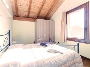 a bedroom with a large bed and a window at Rododendro House - Lake View and Pool Relax in Morbio