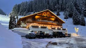 a building with cars parked outside of it in the snow at Chasa Monthani in Ischgl