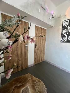 a room with a tree with pink flowers on it at Apartmány Blatec in Blatec