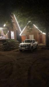 a car parked in front of a house at night at Cabañas Rucahue in Pucón