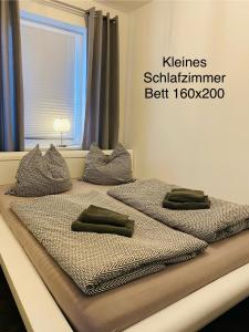 2 Betten mit Kissen in einem Schlafzimmer in der Unterkunft FEWO am Wald in Krauschwitz