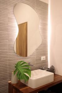a bathroom with a white sink and a mirror at Villas Mar y Coral in Puerto Viejo