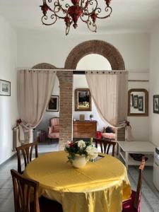 a dining room with a yellow table and chairs at CriLo Pisa in Pisa