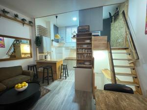 a small apartment with a staircase and a living room at Luminoso y acogedor bajo en Tetuán by beBalmy in Madrid