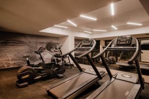 a gym with several tread machines in a room at VacationClub – Lwowska 2C Apartament 14 in Kołobrzeg