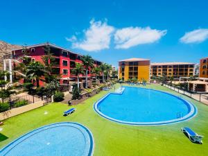 an overhead view of a swimming pool at a resort at Family apartment GRAND in Palm-mar