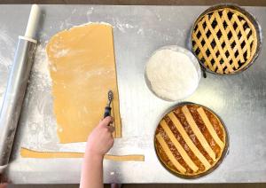 a person cutting a piece of cheese with a scissors at Hotel Oasi in San Vito di Cadore +43 photos