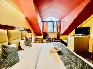 1 dormitorio con 1 cama grande en The Kalinga Resort Manali - Heaven In Mountains en Manāli