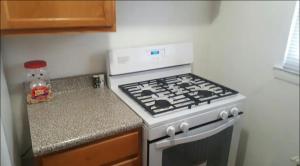 a kitchen with a stove and a counter top at Suite 55 in Elmwood Park