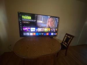 a flat screen tv sitting on top of a wooden table at Suite 55 in Elmwood Park