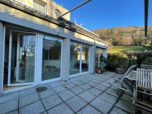 a patio with sliding glass doors on a house at Villa Rebgärtle mit Seeblick in Bregenz