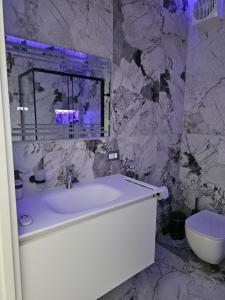 a bathroom with a white tub and a toilet at Aliss Appartamenti in Negrar +43 photos