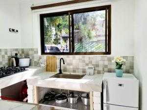 a kitchen with a sink and a window at Retreat Homes in Dar es Salaam