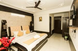 a bedroom with a bed and a ceiling fan at Mirage Grand in McLeod Ganj
