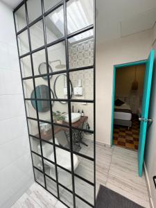 a room with a glass partition with a sink at CASA HOTEL LAS HORTENSIAS in Jardin