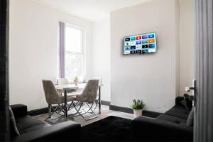 a living room with a table and two chairs at Superb House near Downtown Liverpool in Liverpool