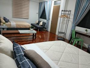 a living room with a bed and a couch at Summer Homestay@civic centre in Sibu